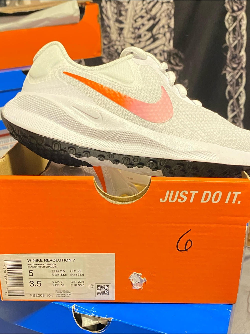 Nike White Running Shoe with Pink-Orange Swoosh